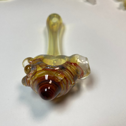 Glass pipe with brown and clear colors on a white background